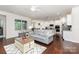 Spacious living room features hardwood floors, a comfortable sofa, and abundant natural light from the window at 1663 Tranquility Blvd, Lancaster, SC 29720