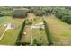 Aerial view of a vast property with a well-maintained lawn, trees and a home with multiple outbuildings at 1720 Lowe Dr, Catawba, NC 28609