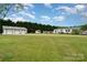 Exterior shot showcasing a spacious detached garage with multiple bays and a view of the home at 1720 Lowe Dr, Catawba, NC 28609
