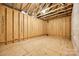 Unfinished basement with exposed framing, wooden floors, and a blank canvas for customization at 173 Morgans Branch Rd, Belmont, NC 28012