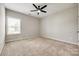 Cozy bedroom with neutral walls, plush carpet, a ceiling fan, and a bright window at 173 Morgans Branch Rd, Belmont, NC 28012