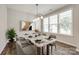 Elegant dining room with a modern light fixture, large windows, and stylish decor at 173 Morgans Branch Rd, Belmont, NC 28012