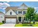 Charming two-story home features a manicured lawn, stone accents, and an attached two-car garage at 173 Morgans Branch Rd, Belmont, NC 28012