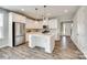 Bright, open kitchen with a large island, stainless steel appliances, and stylish white cabinets at 173 Morgans Branch Rd, Belmont, NC 28012