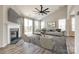 Bright living room with a fireplace, vaulted ceiling, large windows, and a ceiling fan at 173 Morgans Branch Rd, Belmont, NC 28012