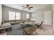 Neutral living room featuring a ceiling fan, sofa, chairs, tables, and carpet at 173 Morgans Branch Rd, Belmont, NC 28012