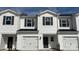 Charming townhome with white siding, black shutters, and a one-car garage, showcasing modern curb appeal at 1750 Old Rivers Rd, Concord, NC 28027