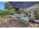 Beautiful backyard with stone patio, outdoor furniture, and a view of the house and pergola at 1849 Still Water Ln, Indian Land, SC 29707