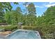 Relaxing hot tub overlooking a serene lake surrounded by lush greenery at 1849 Still Water Ln, Indian Land, SC 29707