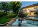 Beautiful backyard featuring a swimming pool, lush landscaping, and a covered patio at 1849 Still Water Ln, Indian Land, SC 29707