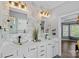 Elegant bathroom with glass vessel sinks, decorative mirrors, and stylish wallpaper at 1849 Still Water Ln, Indian Land, SC 29707