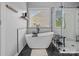 Modern bathroom featuring a freestanding tub, glass shower, and sleek black accents at 1849 Still Water Ln, Indian Land, SC 29707
