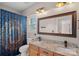Full bathroom with a wooden vanity, double sinks, and a toilet and shower in background at 1849 Still Water Ln, Indian Land, SC 29707
