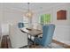 Elegant dining room with a rustic table, chandelier, and wainscoting at 1849 Still Water Ln, Indian Land, SC 29707