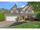 Beautiful two-story home with a stone veneer, a two-car garage, and a beautifully landscaped front yard at 1849 Still Water Ln, Indian Land, SC 29707