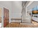 Bright foyer boasts wood floors, a staircase, mudroom-style bench with hooks, and a solid wood front door at 1849 Still Water Ln, Indian Land, SC 29707