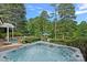 Inviting hot tub with lush landscaping and a picturesque view of the lake at 1849 Still Water Ln, Indian Land, SC 29707