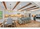 Stylish kitchen with white cabinets, stone island, wine fridge, and hardwood flooring at 1849 Still Water Ln, Indian Land, SC 29707