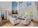 Open living room featuring a fireplace, a large tv, and large windows with a view of the trees at 1849 Still Water Ln, Indian Land, SC 29707