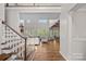 Spacious living room featuring a staircase, hardwood floors, and many windows that provide great natural light at 1849 Still Water Ln, Indian Land, SC 29707