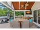 Covered outdoor kitchen featuring a built-in grill, hot tub, gas fireplace, and TV at 1849 Still Water Ln, Indian Land, SC 29707