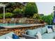 In-ground pool with rock waterfall feature and lush landscaping creating a private backyard retreat at 1849 Still Water Ln, Indian Land, SC 29707