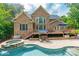 Brick home showcases a back porch, pool, and spa, creating a serene outdoor oasis at 1868 Chestnut Hill Dr, Tega Cay, SC 29708