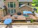 Aerial view of a large brick home with a spacious wooden deck, outdoor kitchen, grill, and pool at 1868 Chestnut Hill Dr, Tega Cay, SC 29708