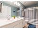 Bathroom featuring double sinks, tiled floors, a shower with a tub and vanity lighting at 1868 Chestnut Hill Dr, Tega Cay, SC 29708