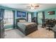 Comfortable bedroom with neutral-colored walls, ceiling fan, two windows and dark furniture at 1868 Chestnut Hill Dr, Tega Cay, SC 29708