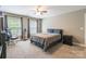 Spacious bedroom with carpet, fan, two windows and an office chair at 1868 Chestnut Hill Dr, Tega Cay, SC 29708