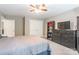 Carpeted bedroom featuring a fan, a closet and a dresser with a TV at 1868 Chestnut Hill Dr, Tega Cay, SC 29708
