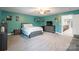 This bedroom has carpeting, a ceiling fan, a dresser with a television and wall decor at 1868 Chestnut Hill Dr, Tega Cay, SC 29708
