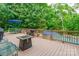 Spacious wooden deck features an outdoor kitchen, a dining area, and overlooks the pool at 1868 Chestnut Hill Dr, Tega Cay, SC 29708