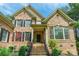 Inviting brick home with a covered entrance and meticulously landscaped front yard at 1868 Chestnut Hill Dr, Tega Cay, SC 29708
