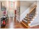 Grand two-story foyer with hardwood floors, staircase, and stylish decor at 1868 Chestnut Hill Dr, Tega Cay, SC 29708