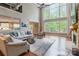 Bright living room with soaring ceilings, large windows, and comfortable seating at 1868 Chestnut Hill Dr, Tega Cay, SC 29708