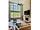 Bright living room with a stone fireplace, large windows, and hardwood floors at 1868 Chestnut Hill Dr, Tega Cay, SC 29708