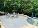 Outdoor patio featuring a fire pit, comfortable seating, and a view of the pool and surrounding greenery at 1868 Chestnut Hill Dr, Tega Cay, SC 29708
