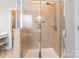 Modern glass shower with tiled walls and showerhead in the primary bathroom at 1868 Chestnut Hill Dr, Tega Cay, SC 29708
