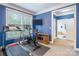 Versatile workout room features a treadmill, exercise bike, mounted television, and ensuite bath at 1868 Chestnut Hill Dr, Tega Cay, SC 29708
