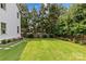 Spacious backyard with lush green grass, lovely landscaping, and an area with trampoline and accessories at 206 Hillside Ave, Charlotte, NC 28209