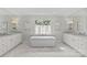 Bright bathroom features a standalone tub beneath a window and dual vanities at 206 Hillside Ave, Charlotte, NC 28209