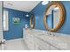 Bathroom with dual sinks, marble countertops, rope mirror, and blue walls at 206 Hillside Ave, Charlotte, NC 28209