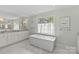 Bright bathroom features a standalone tub beneath a window and a vanity at 206 Hillside Ave, Charlotte, NC 28209
