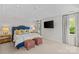 Spacious bedroom with a tray ceiling, plush carpet, and a large mounted TV at 206 Hillside Ave, Charlotte, NC 28209