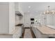This bright kitchen features a center island with stainless steel stove, marble countertops, and cabinetry at 206 Hillside Ave, Charlotte, NC 28209