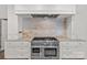 The kitchen features stainless steel appliances, marble counters and backsplash and a gas range at 206 Hillside Ave, Charlotte, NC 28209