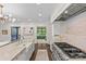 The kitchen features an island with a prep sink and gas cooktop range, with stainless steel appliances at 206 Hillside Ave, Charlotte, NC 28209