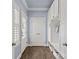 This mudroom features blue wallpaper, white cabinets, and a wooden floor at 206 Hillside Ave, Charlotte, NC 28209